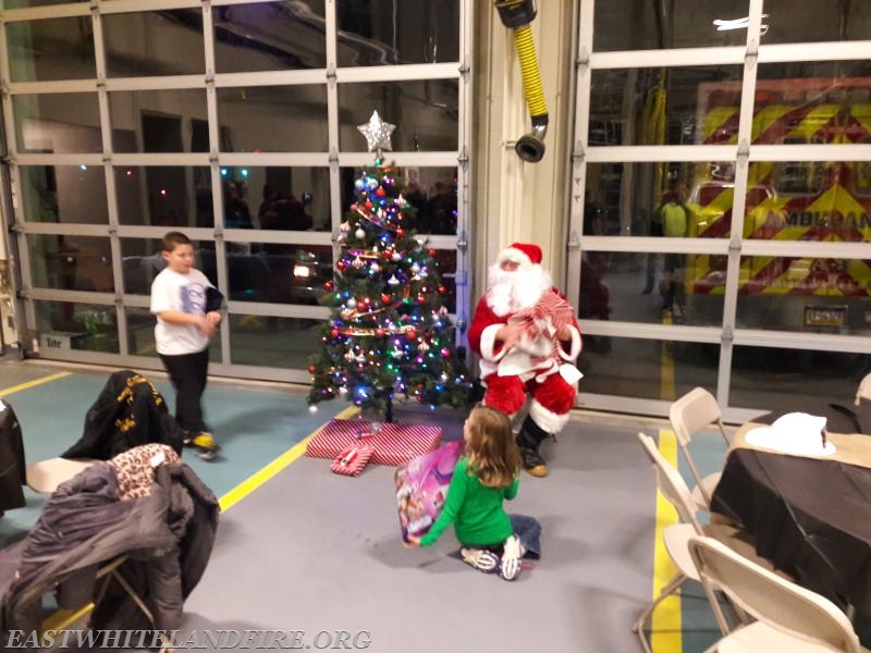 Santa was handing out gifts to children during our company Christmas party in December 2016 at Station 5.